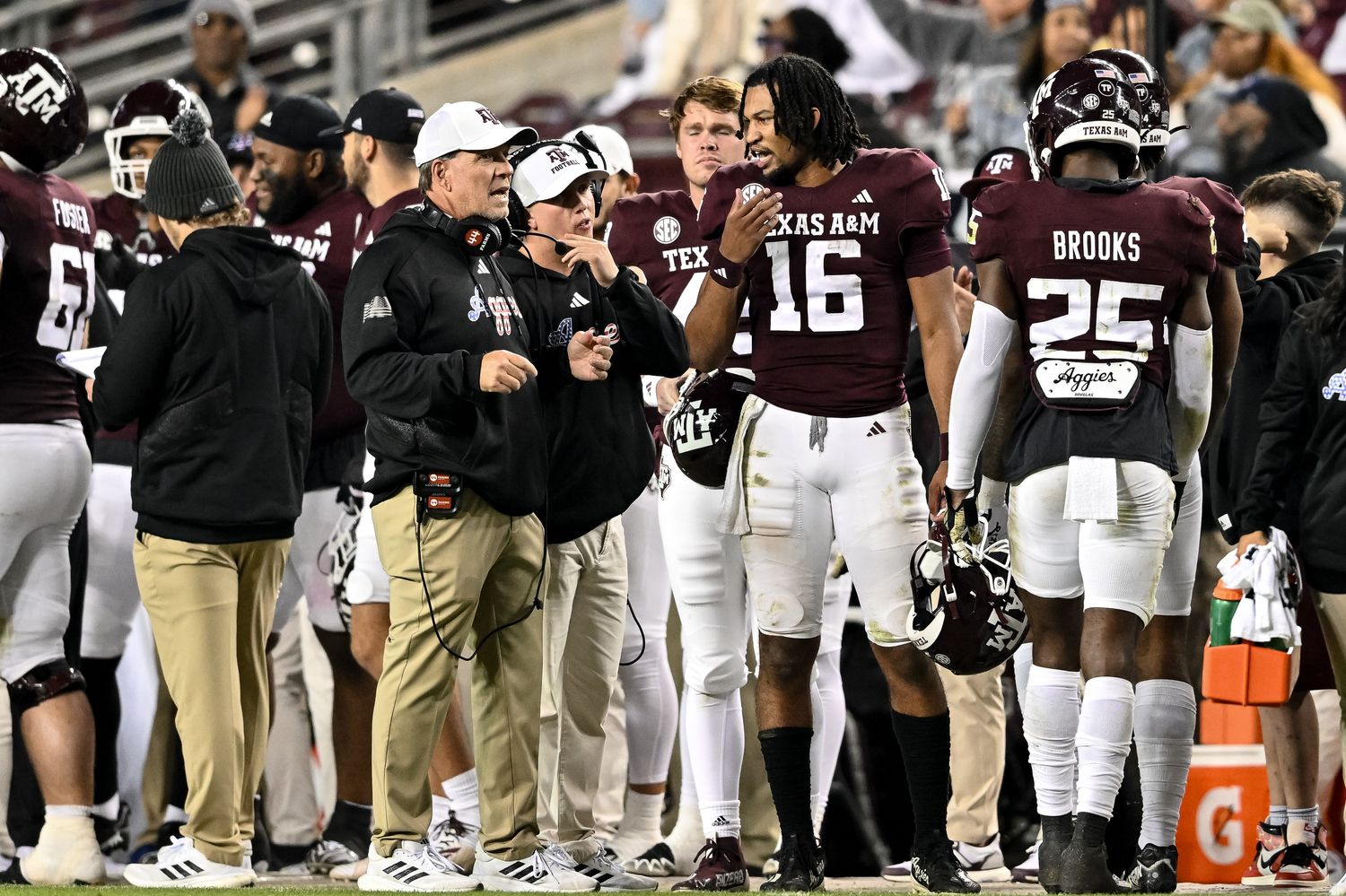 Nov 11, 2023; College Station, Texas, USA; Texas A&M Aggies quarterback Jaylen Henderson (16) speaks with head coach Jimbo Fisher during the second half against the Mississippi State Bulldogs at Kyle Field. Mandatory Credit: Maria Lysaker-USA TODAY Sports